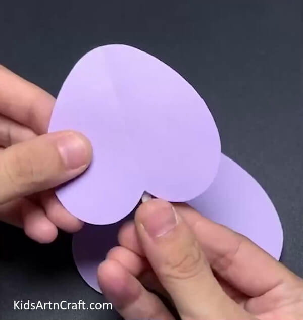 Adding The Rodent Teeth- A step-by-step guide to creating a mouse with a heart-shaped piece of paper.