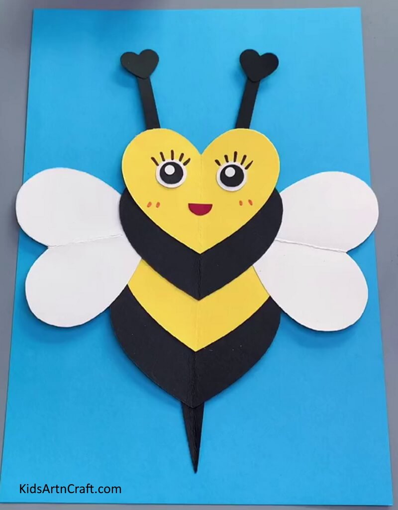 A basic bee craft in the shape of a heart