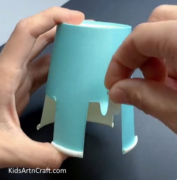 Folding Along Creases To Give Proper Shape To The Animal Teach Kids How To Make an Elephant Paper Cup Art 