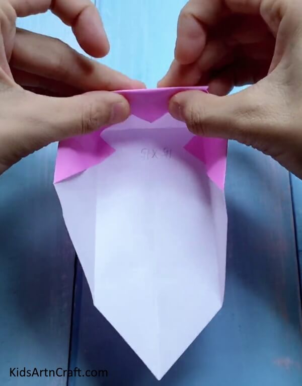 Folding Top Triangle - Crafting a mini origami paper bag is a fun project for kids.