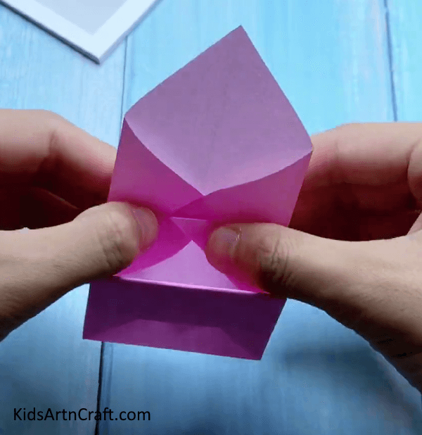 Folding Side Triangles - Children can construct a miniature origami paper bag. 