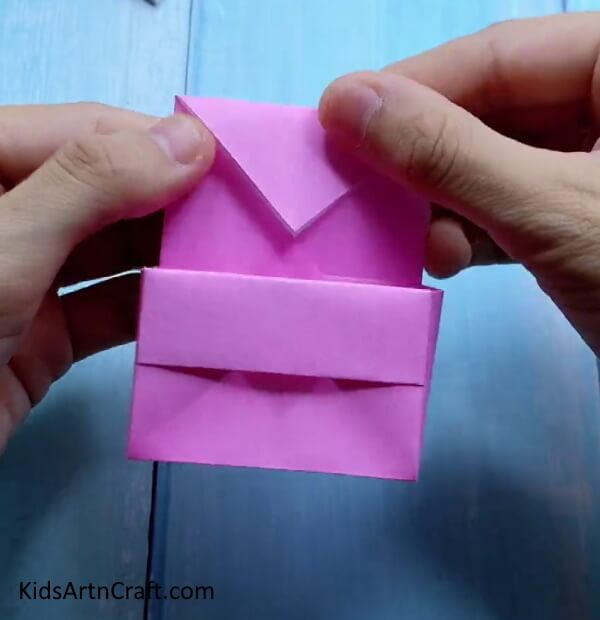 Folding Top Triangle - Creating a mini origami paper bag is an activity for kids. 