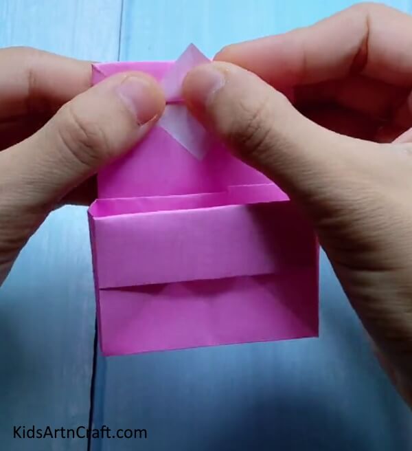 Folding Triangle Upwards - Little ones can make their own mini paper bag out of origami. 