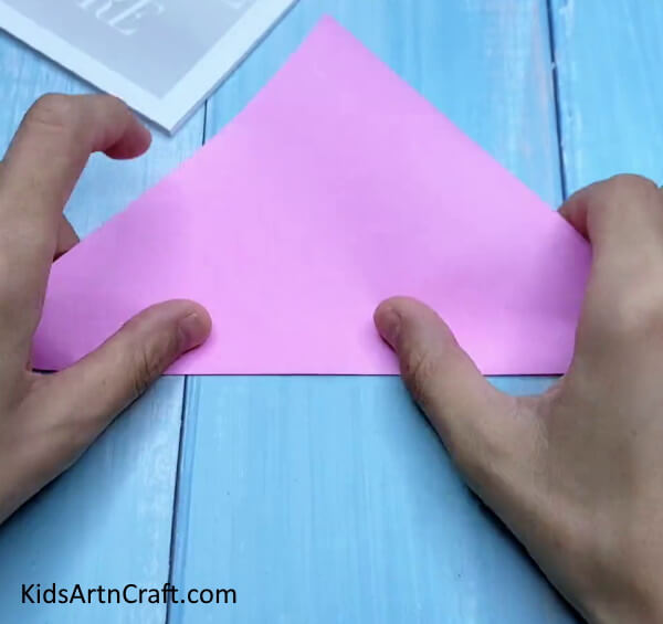 Folding Paper In Half Diagonally - Little ones can create a tiny origami paper bag.