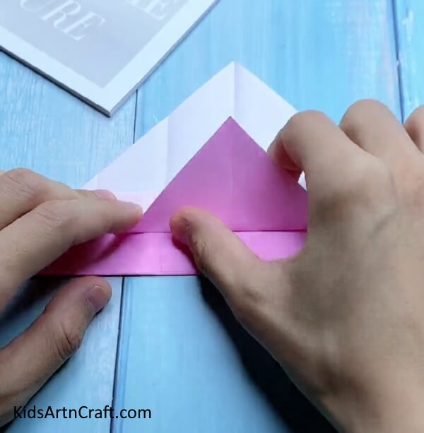 Folding Triangle Upwards - Small origami paper bags are a great craft for kids.