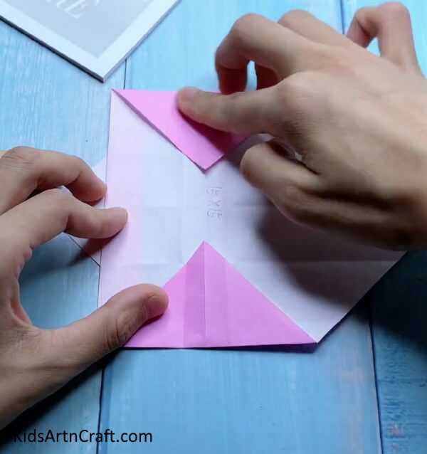 Folding Triangles - Building a mini origami paper bag is a great activity for children.