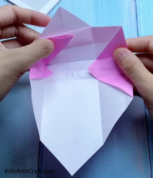 Pushing in The Left Corner - Children can have a blast making a miniature origami paper bag.