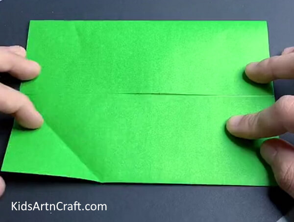 Folding Sides Of The Paper To The Middle - Learn how to craft a paper dinosaur by origami
