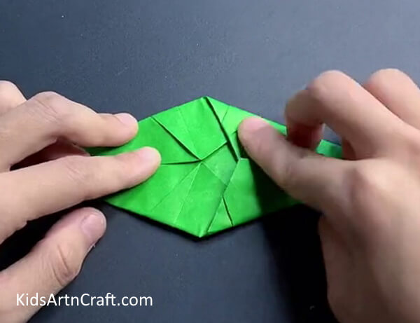 Folding Right Sides - Discover how to construct a paper dinosaur with this origami guide.