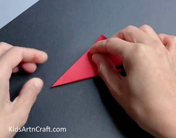 Fold The Bottom Tip Learn to make paper snowflakes with this uncomplicated tutorial