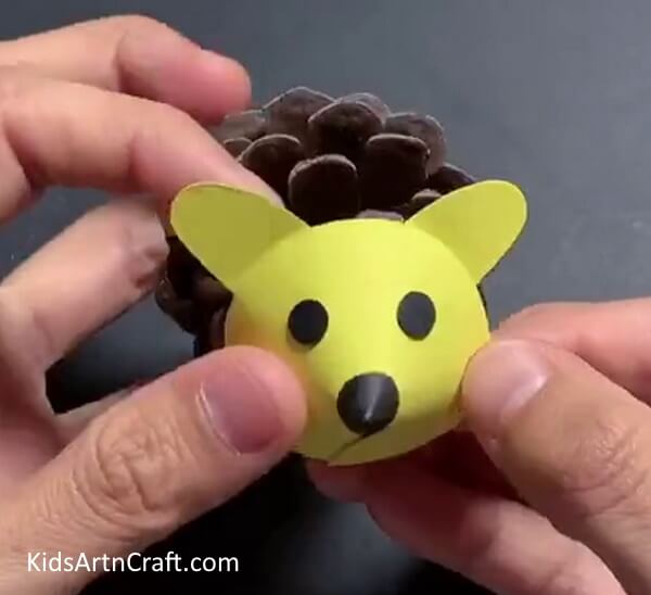 Pasting Face On Pine Cone - Make a Pine Cone Mouse Craft For the Youngsters