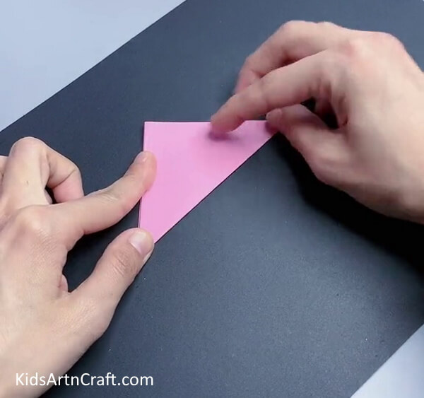 Folding Square Into Triangle - Making a tulip paper flower is simple for youngsters. 