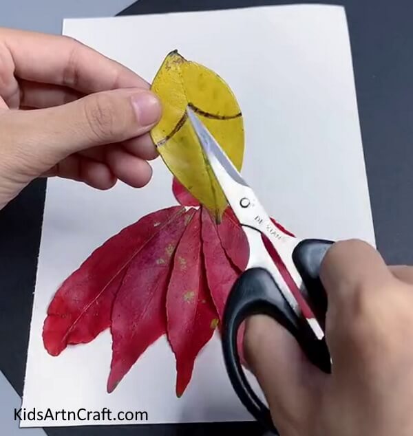 Cutting the leaf. Creative artwork of fall leaf for Kids