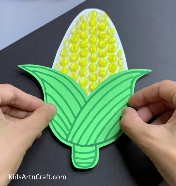 Pasting Leaf On Corn - Directions for Constructing a Bubble Wrap Corn Piece with Your Own Hands