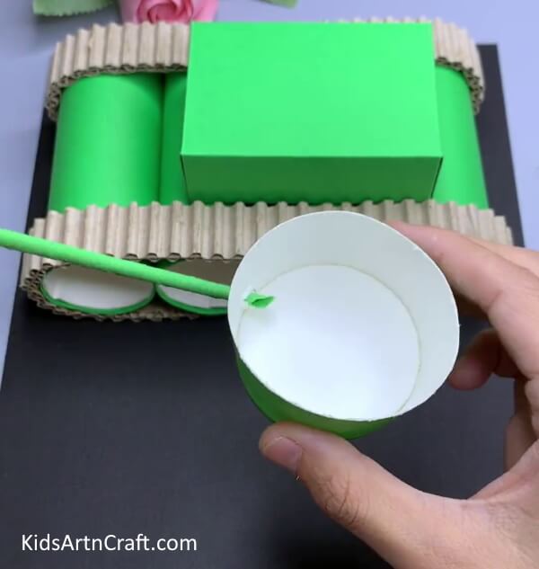 Inserting Green Stick In Paper Cup Hole - Fabricate a Recycled Cardboard Tube & Paper Cup Tank Craft In Your House