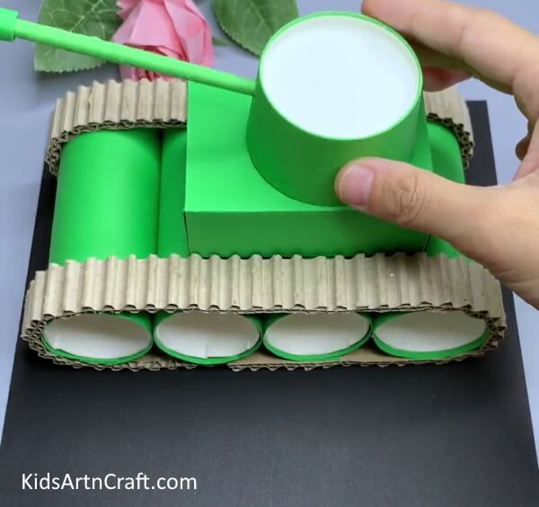 Placing Paper Cup On Tank's Top - Construct a recycled cardboard tube and paper cup tank from the comfort of your own home.