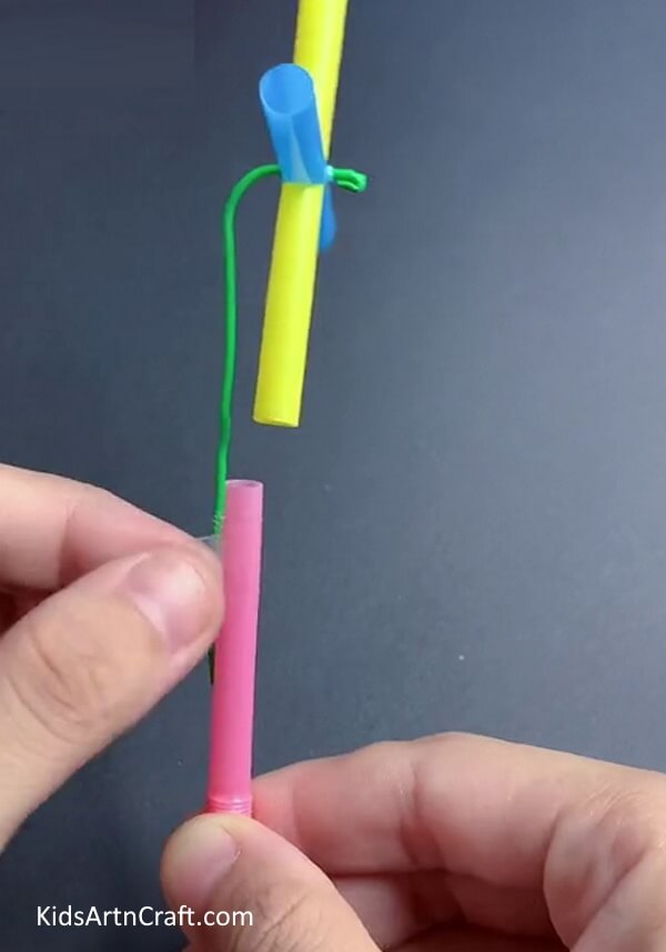 Attaching Other Straw To Paper Clip - Try This Tutorial To Construct A Straw Fan Craft For Kids