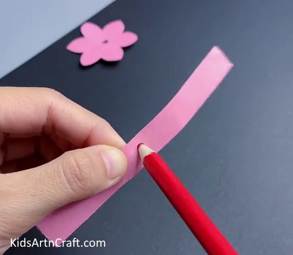 Take a Paper Strip And Make a Hole At The Center-An easy-to-follow guide to making a paper flower ring