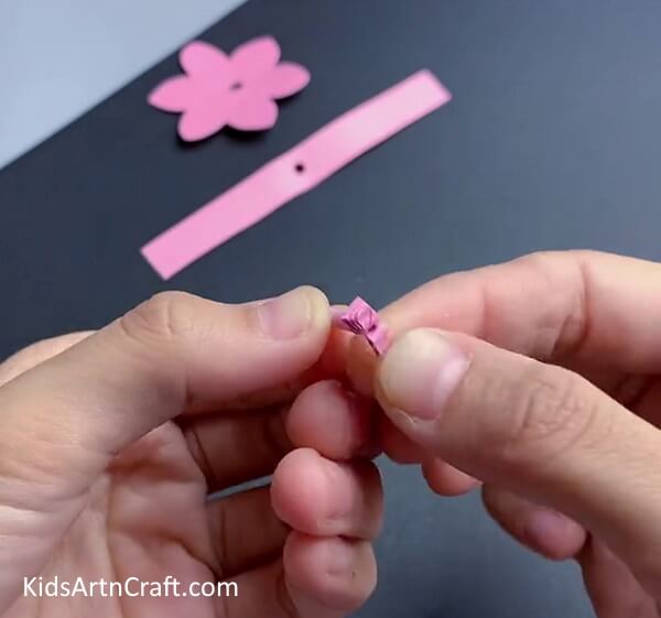 Folding The Strip In Half-Learn how to make a paper flower ring through this tutorial