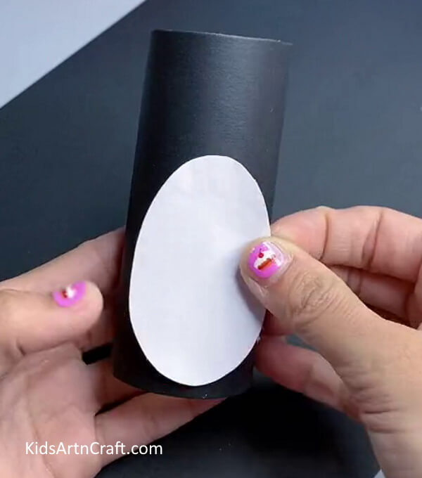 Pasting An Oval On Roll - Designing a penguin with a toilet paper roll for young ones