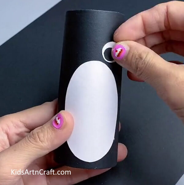 Making Eyes Of Penguin - Hand-crafted bathroom tissue roll penguin art for kids
