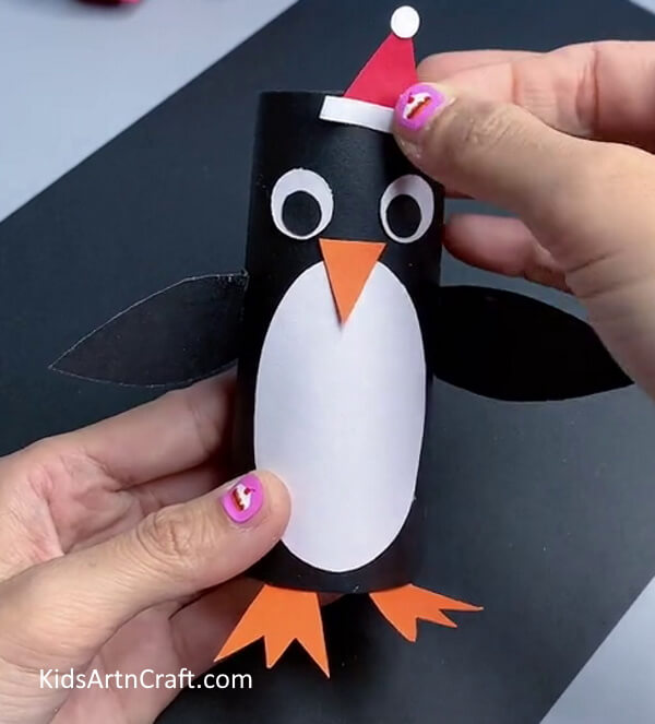 Completing Hat - Building a penguin from a toilet tissue holder for children