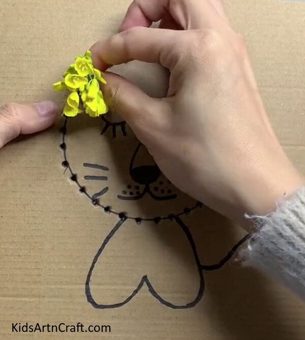 Inserting Flowers In Holes - Forming a lion with blossoms, a straightforward activity for young ones 