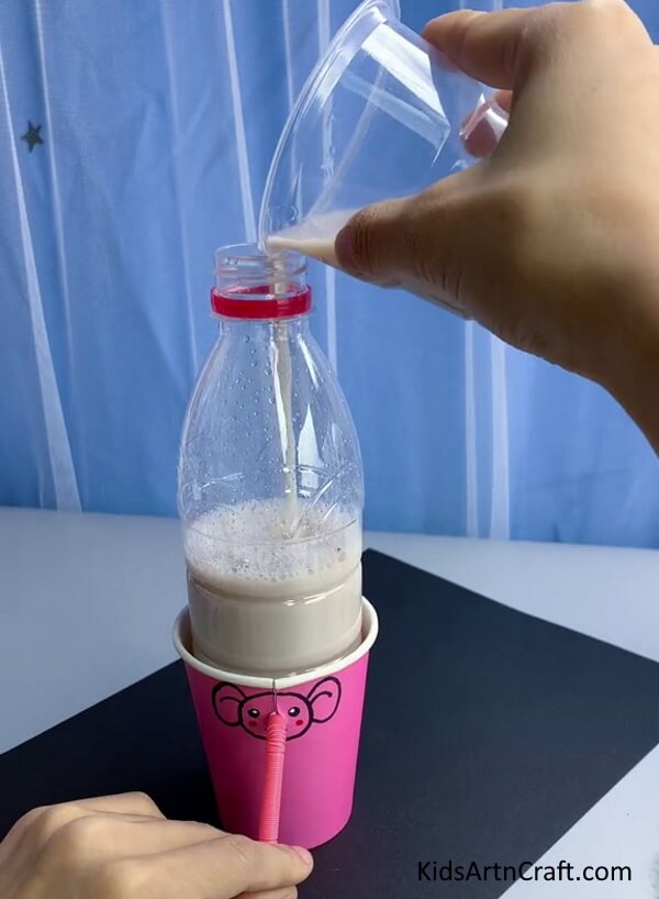 Pouring Water or Chocolate Milk Into The Bottle - Fabricating a Renewable Water Fountain from Plastic Jugs and Drinking Straws