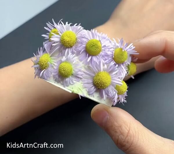Pasting All The Flowers Develop the knack of putting together a flower bracelet using cardboard tubes. 
