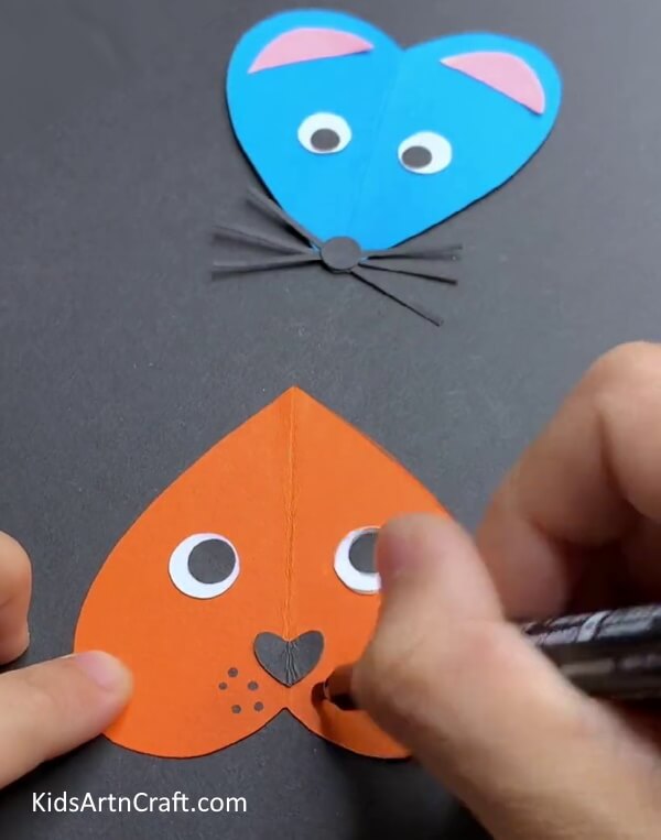 Adding Details Learn the procedure for constructing a paper mouse in the form of a heart