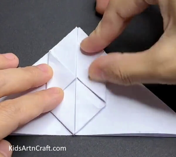 Folding Side Corners Demonstrating To Kids How To Construct A Paper Rabbit 