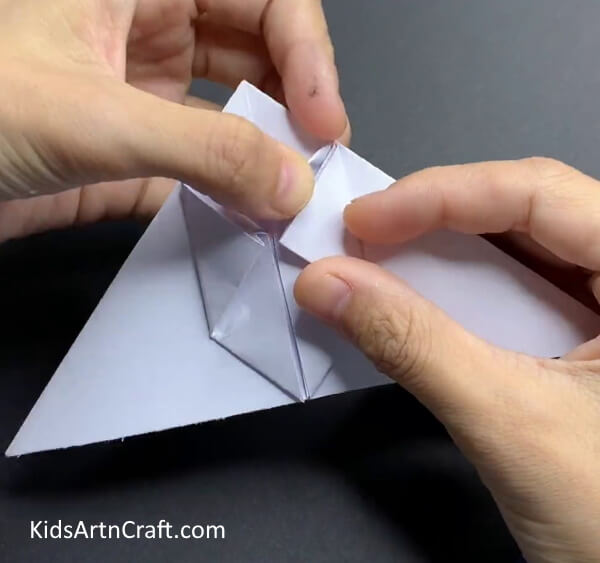 Inserting Upper Corners In The Pocket Showing Children How To Form A Paper Rabbit 