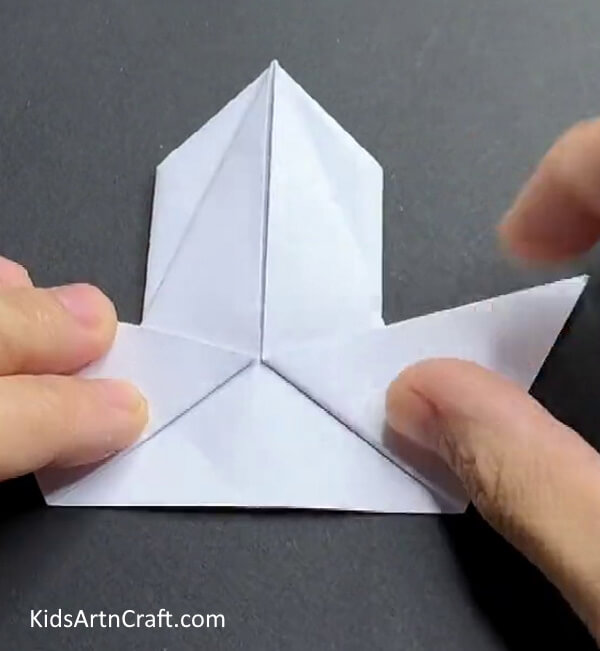 Folding Bottom Corners Showing Youngsters How To Make A Paper Rabbit 