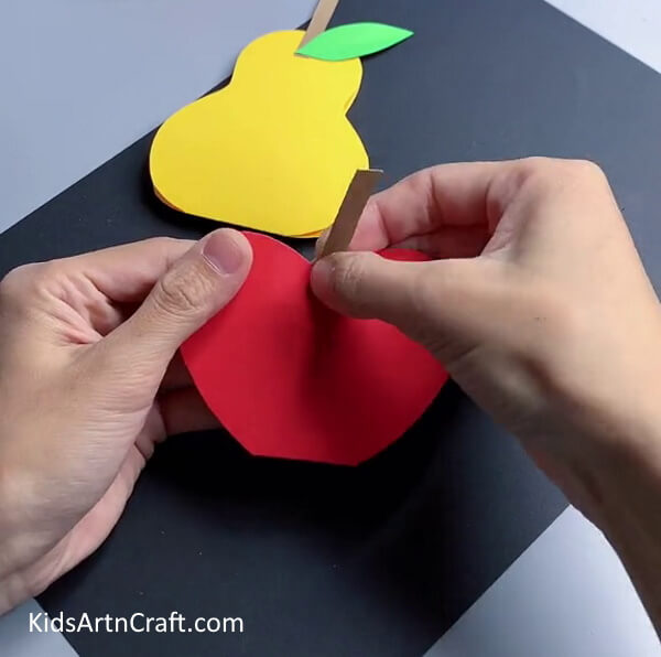 Pasting Stem - Helping kids to form 3D paper fruits.