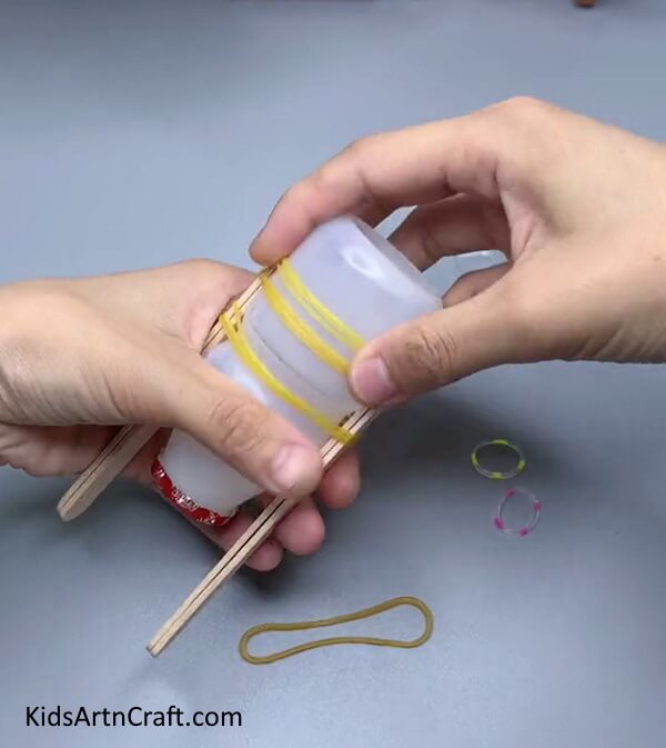 Tying Rubber Bands - Assembling a Rubber Band Bottle Boat with Popsicle Sticks