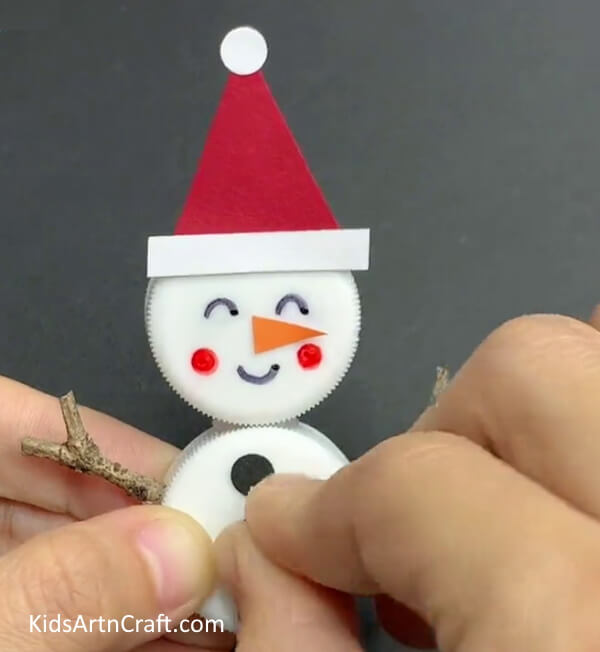 Pasting Buttons And Nose How Children Can Create a Snowman