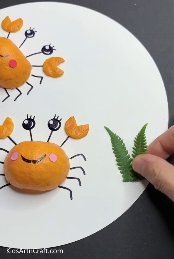 Adding Leaves - A step-by-step tutorial for an orange peel craft with kids