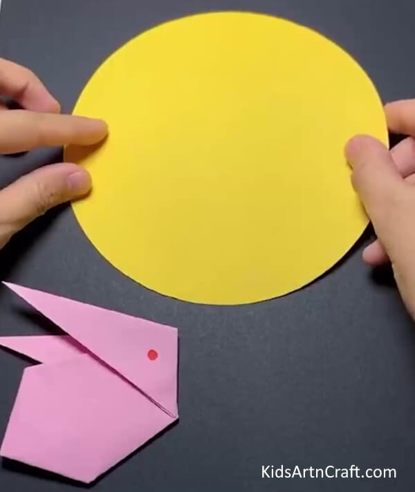 Gluing The Yellow Circle Cut Out As The Sun Learn to Create an Origami Bunny with Yellow Paper Sun 