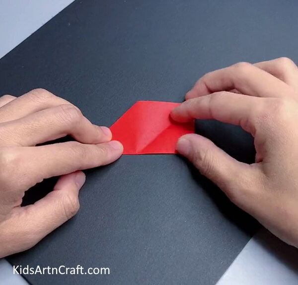 Folding The Paper In Half - Crafting An Origami Ninja Star: Easy Instructions For Children