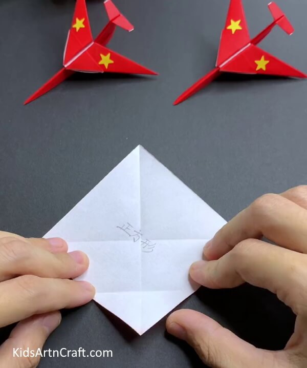 Creasing Square In Half - Constructing a Paper Airplane with Origami