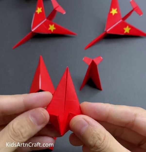 Folding Bottom Corners To The Middle - Putting Together a Papercraft Airplane with Origami