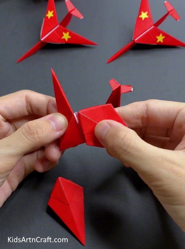 Inserting The Corner In Pockets - Constructing a Paper Plane with Origami