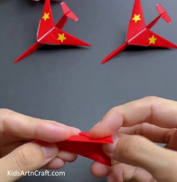 Folding The Model In Half - Building an Origami Plane with Paper