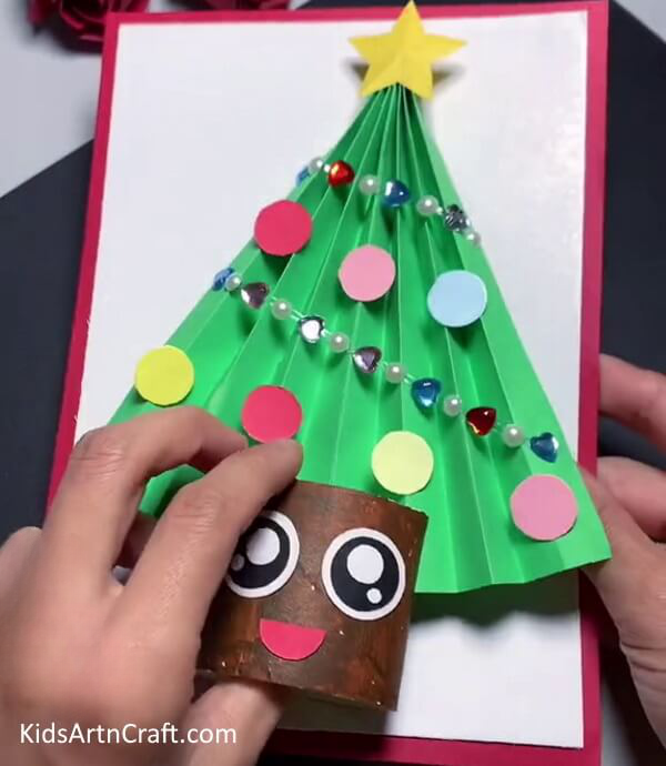 Pasting Tree On Cardboard - A Christmas Tree Paper Craft can easily be made by Kindergarteners.