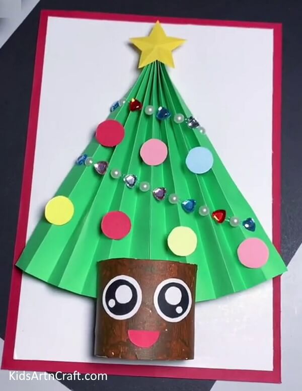 Completing Craft - Creating a Christmas Tree Paper Craft can be done easily by Kindergarteners.
