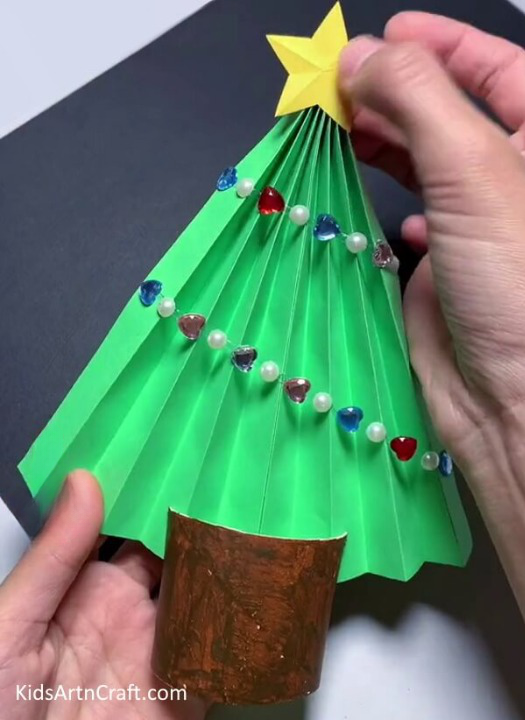 Pasting Star On Top of Tree - Constructing a Christmas Tree Out of Paper for Toddlers