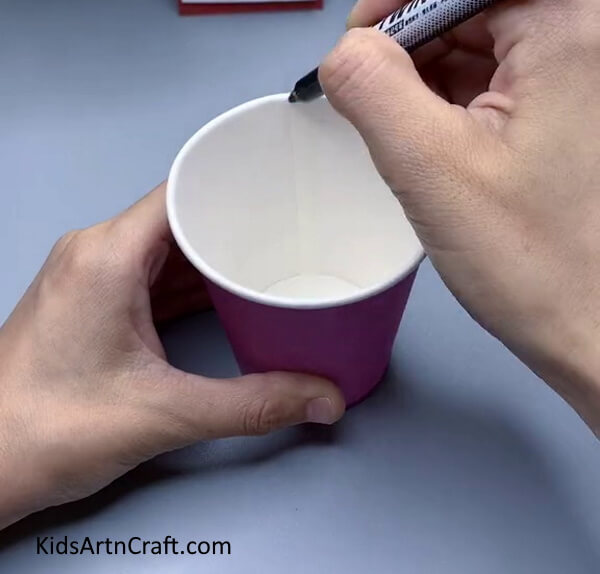 Marking The Paper Cup Using Marker- Making an Octopus Creation Out of Paper Cups for Kids