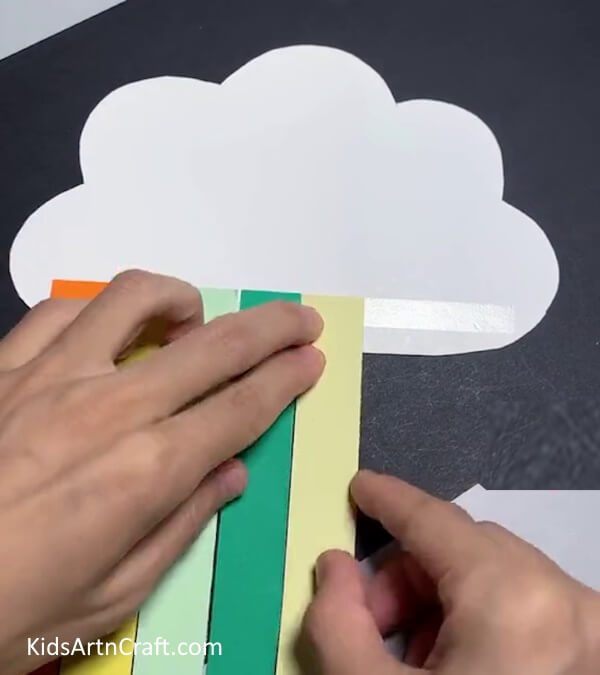 Pasting Rainbow Strips - Crafting a Rainbow Cloud with Paper is a Piece of Cake