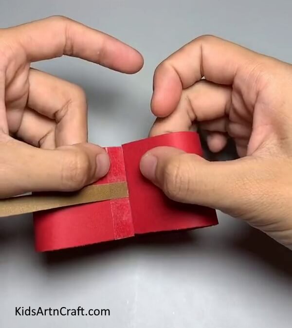 Folding The Red Strip-. Tutorial for creating a Paper Strip Apple Craft with kids