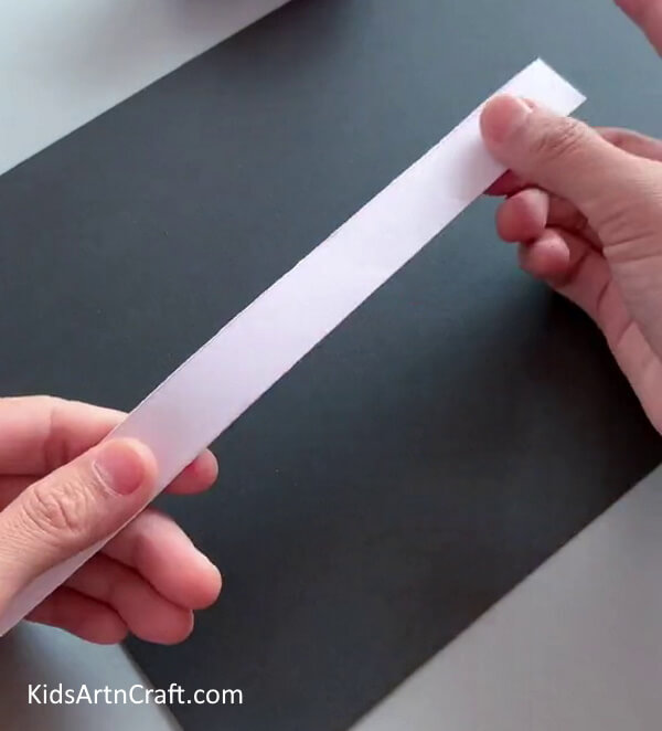 Cut The Two Halves Of The Paper-. Making a Bunny Facade with Paper Strips for Little Ones